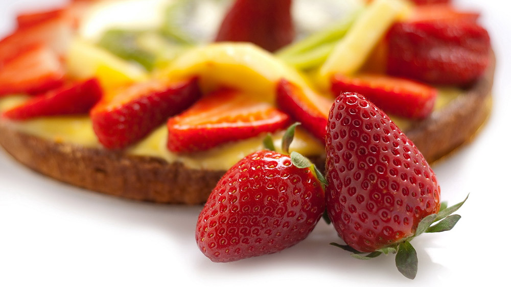 Fresh strawberries and fruit prepared for a meal
